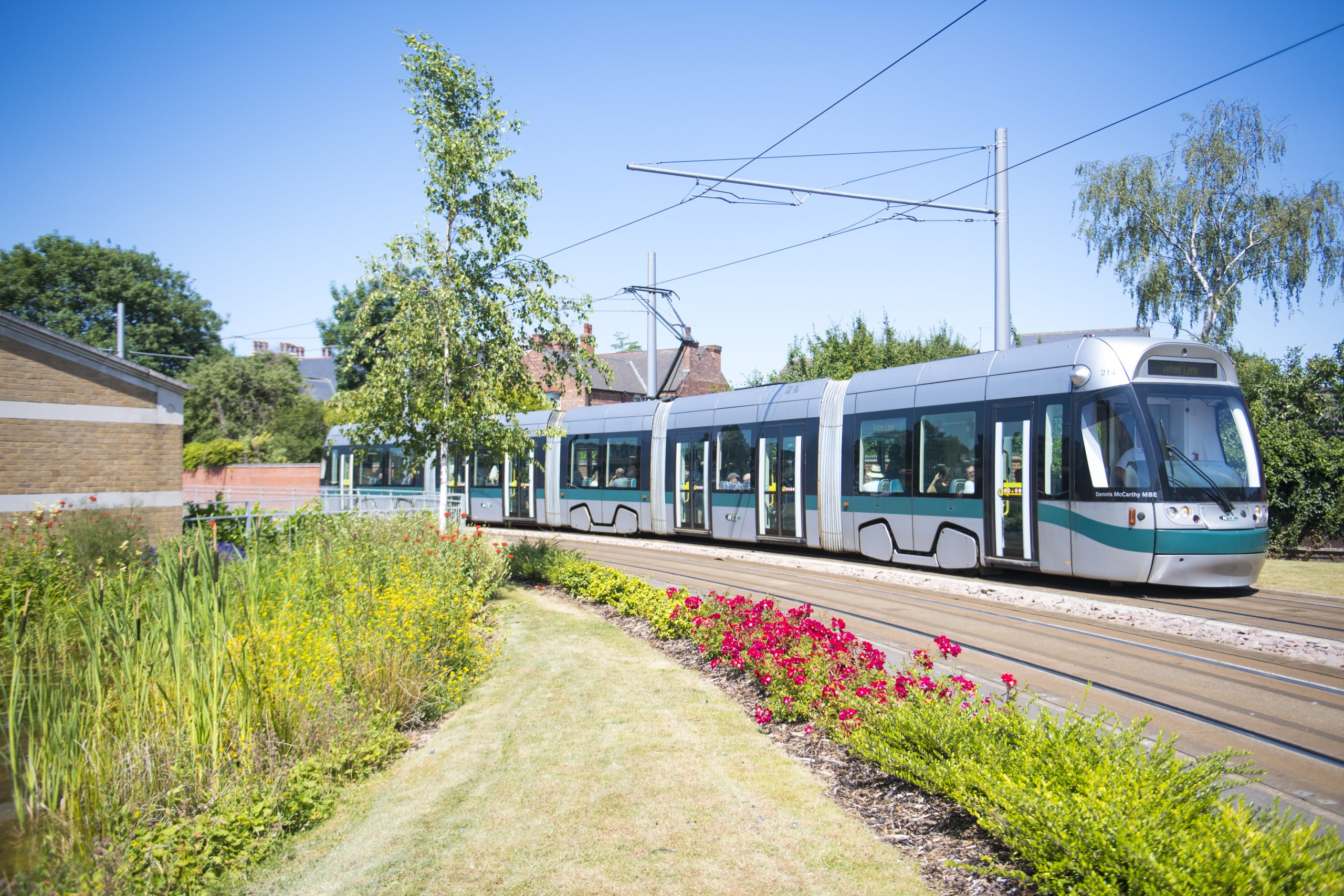 A tram travels past Lakeside Arts