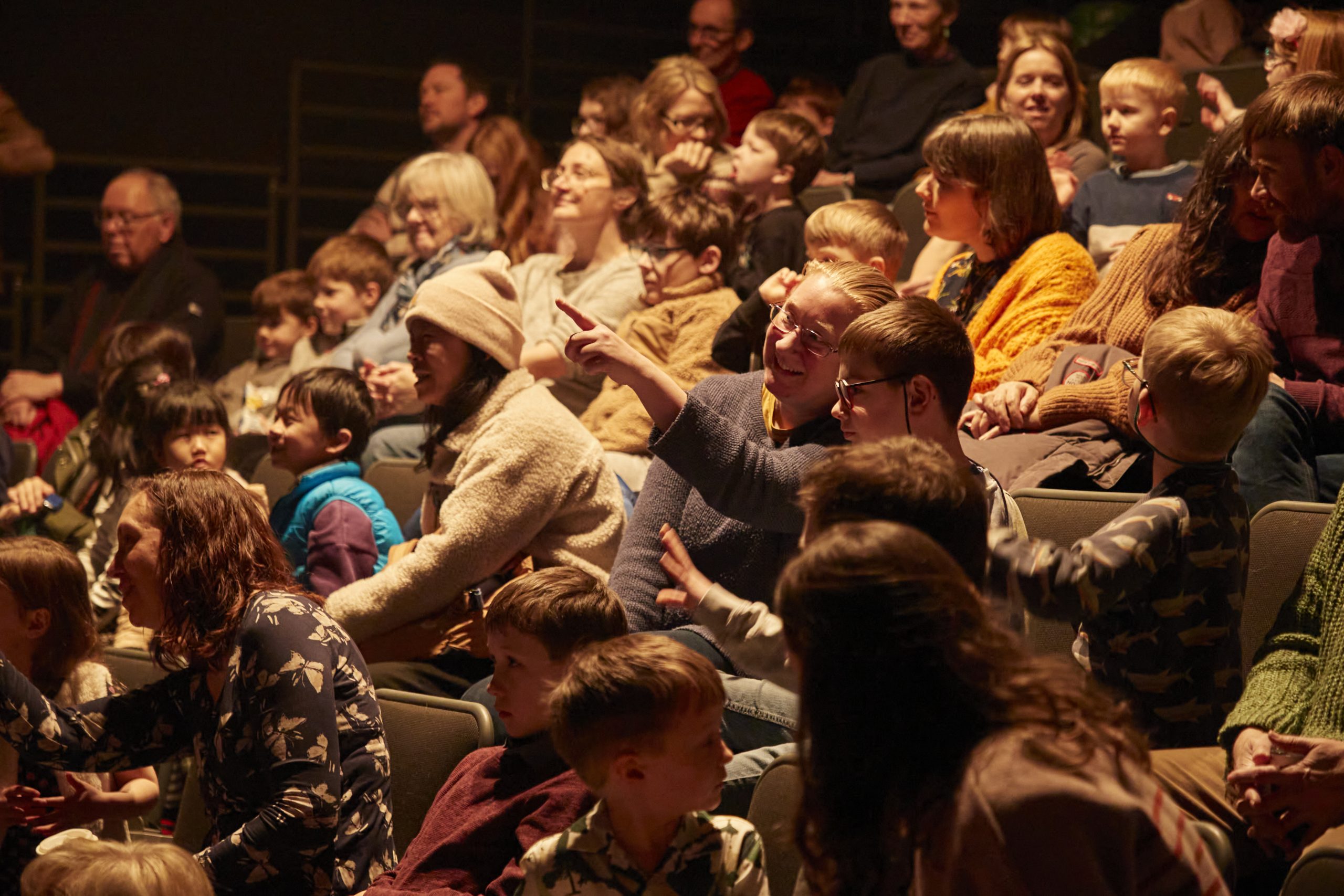 Family audience watching a theatre show