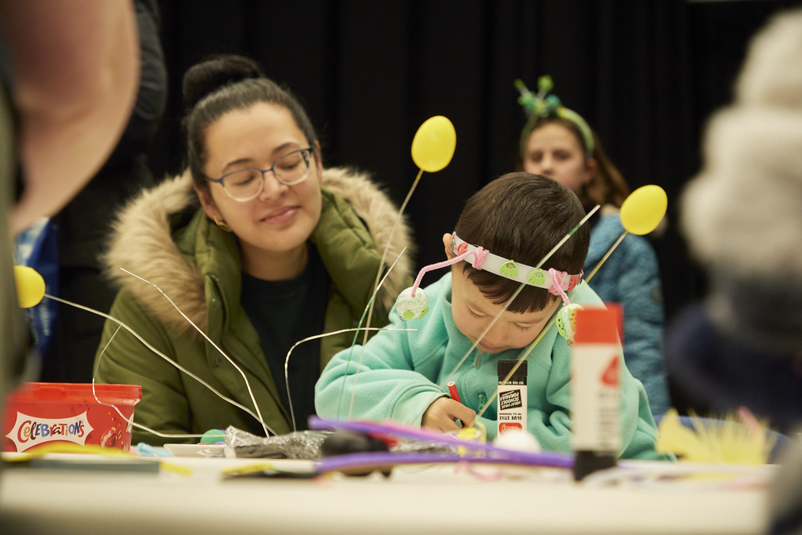 Child and parent working on a craft project