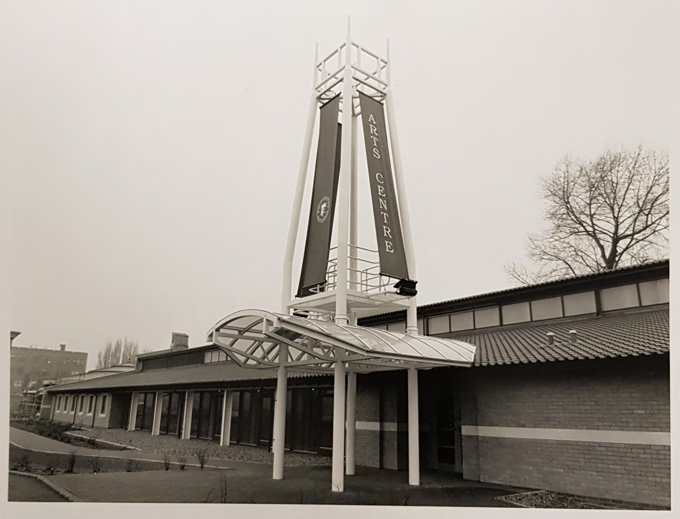 A black and white photo of the exterior of a gallery building with the banner 