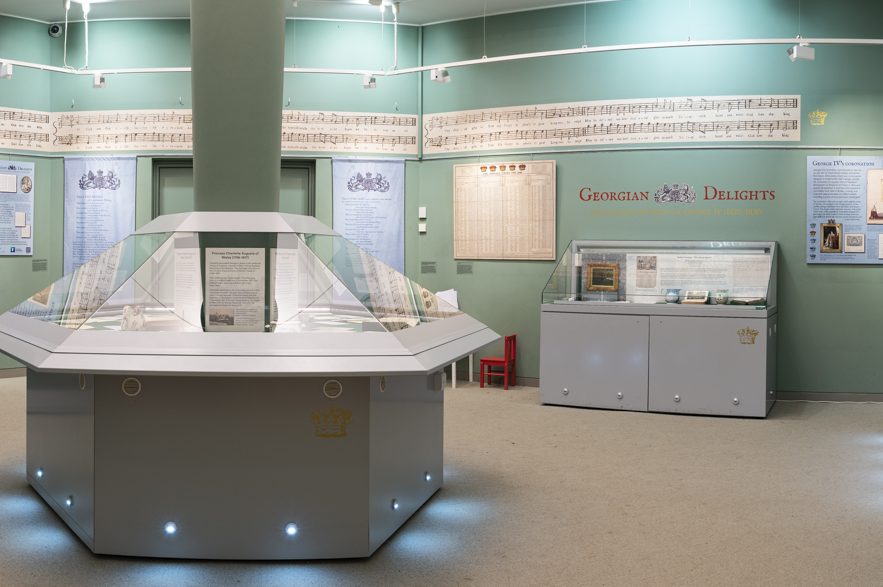 An exhibition space with sage green walls