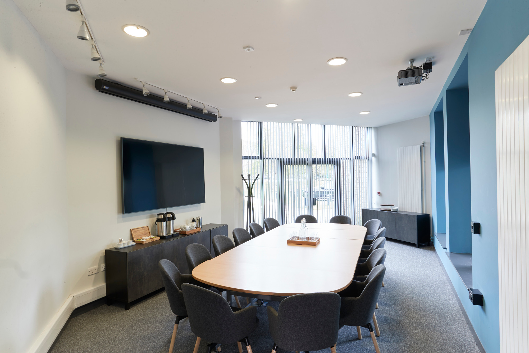 Brightly lit meeting room with a board table and chairs.